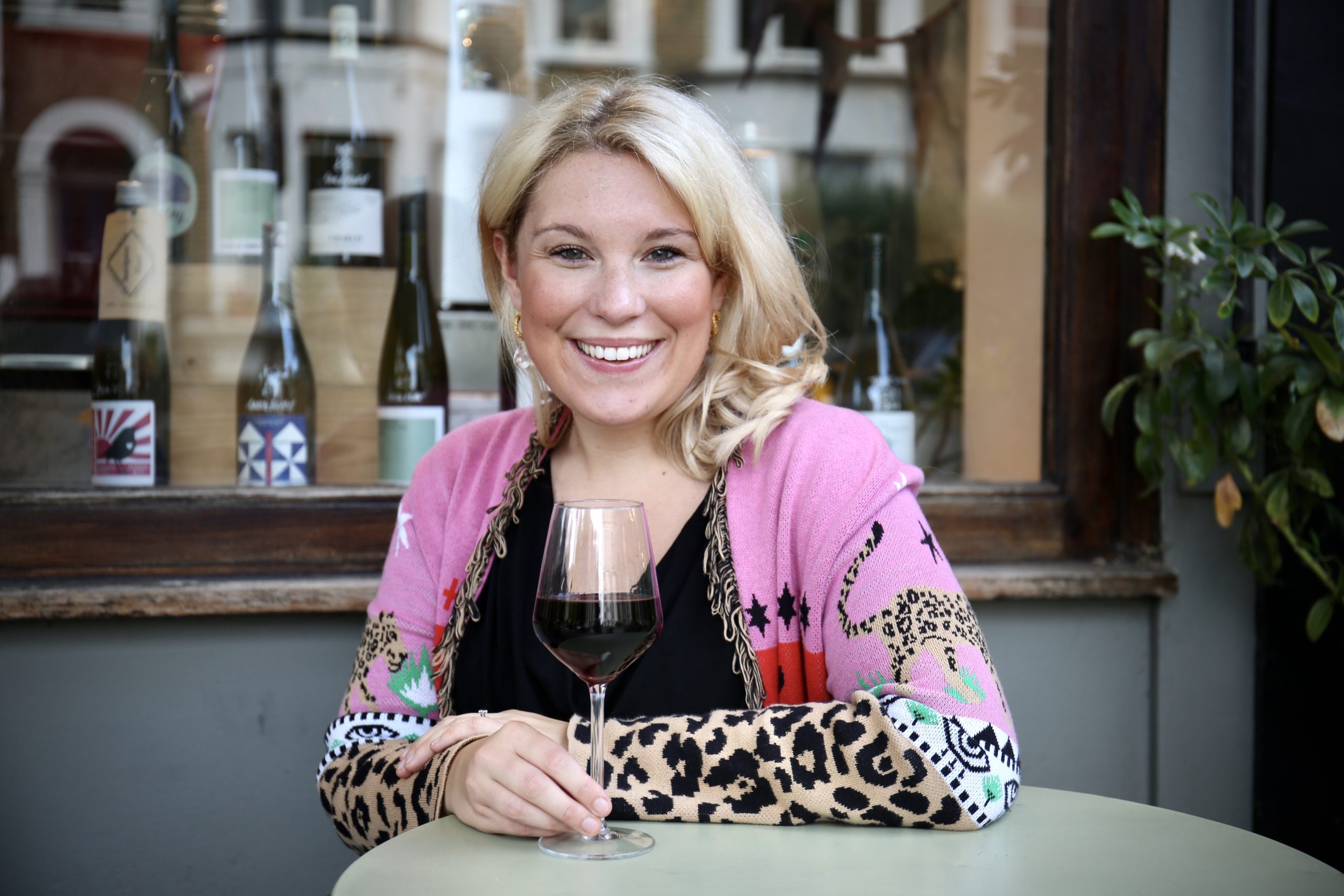 Woman holding a wine glass and smiling
